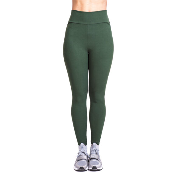 Model stretching in navy blue yoga pants. green